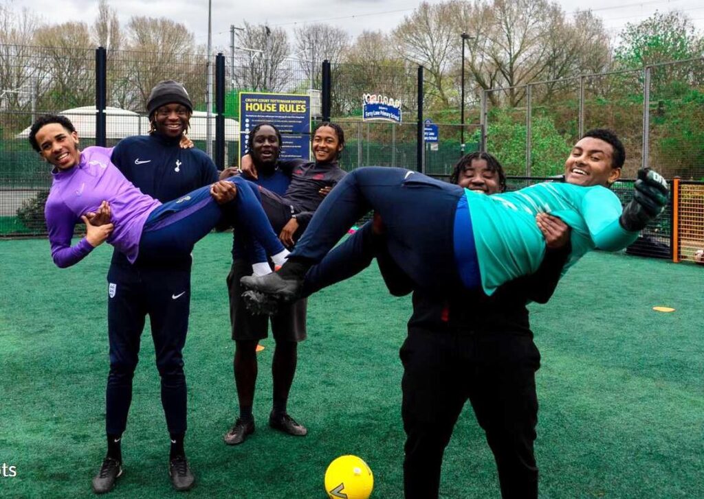 Group of young men lifting each other up