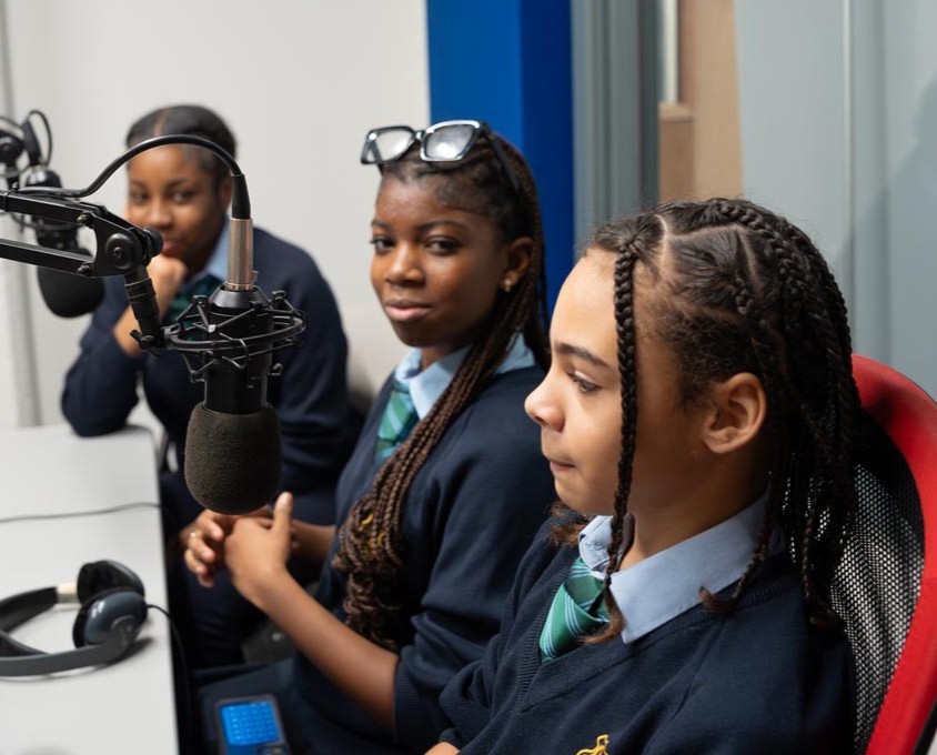 Young people sit in the broadcast room at Unity Xtra Creative Media Hub