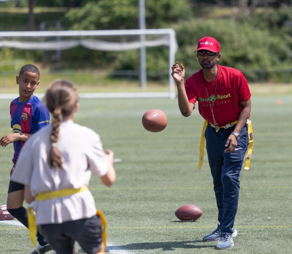 Thru Life staff coach participants in NFL Flag football